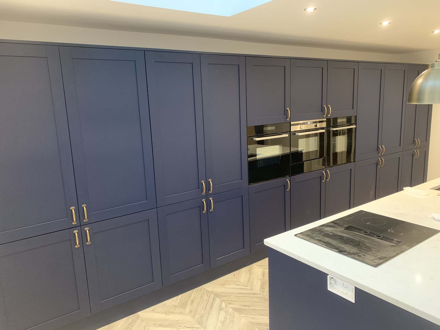 Blue and white kitchen with brass handles 